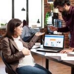 man-pregnant-woman-discuss-office (1)