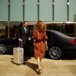 girls Walk For Sitting in chauffeurs Service Car And Driver Steering At her